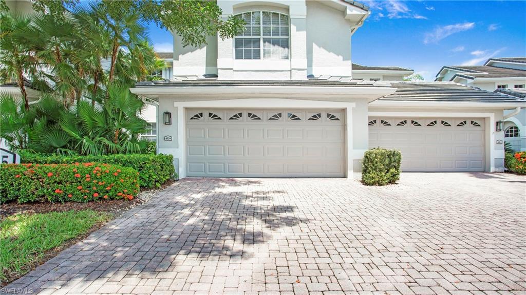 6025 Pinnacle Lane, Unit 6602 Naples, FL 34110 - Photo 24 of 43 a front view of a building with white doors
