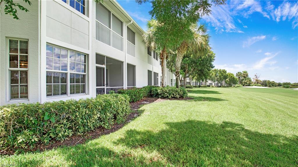 6025 Pinnacle Lane, Unit 6602 Naples, FL 34110 - Photo 27 of 43 a view of a building with a garden