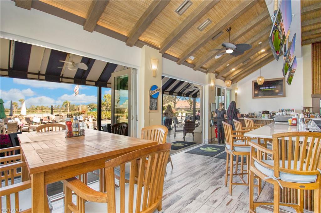 6025 Pinnacle Lane, Unit 6602 Naples, FL 34110 - Photo 36 of 43 a dining hall with furniture and a large window