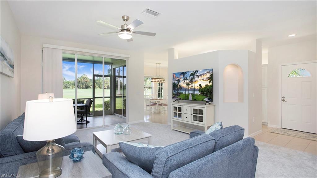 6025 Pinnacle Lane, Unit 6602 Naples, FL 34110 - Photo 10 of 43 a living room with furniture and a flat screen tv