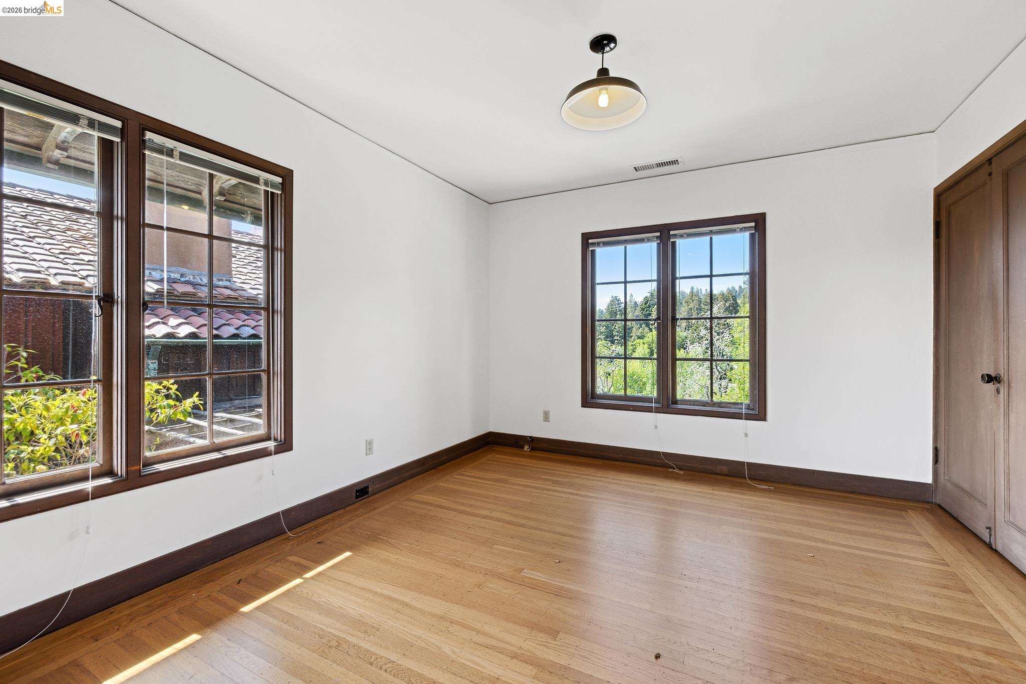2501 Rose Walk Berkeley, CA 94708 - Photo 51 of 60 an empty room with wooden floor and windows
