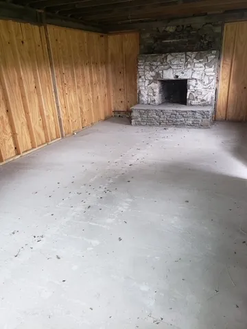 a view of empty room with fireplace