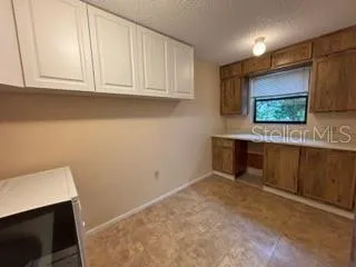 a view of kitchen with stainless steel appliances cabinets