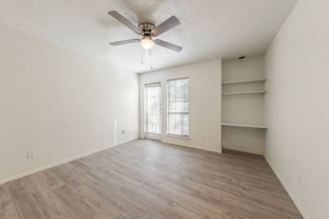 4518 Speedway, Unit B Austin, TX 78751 - Photo 6 of 7 an empty room with wooden floor closet and windows