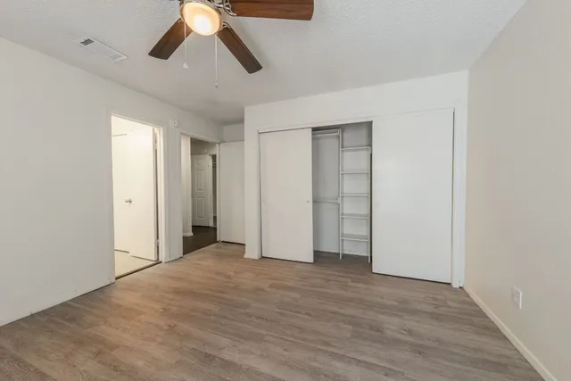 a view of empty room with wooden floor
