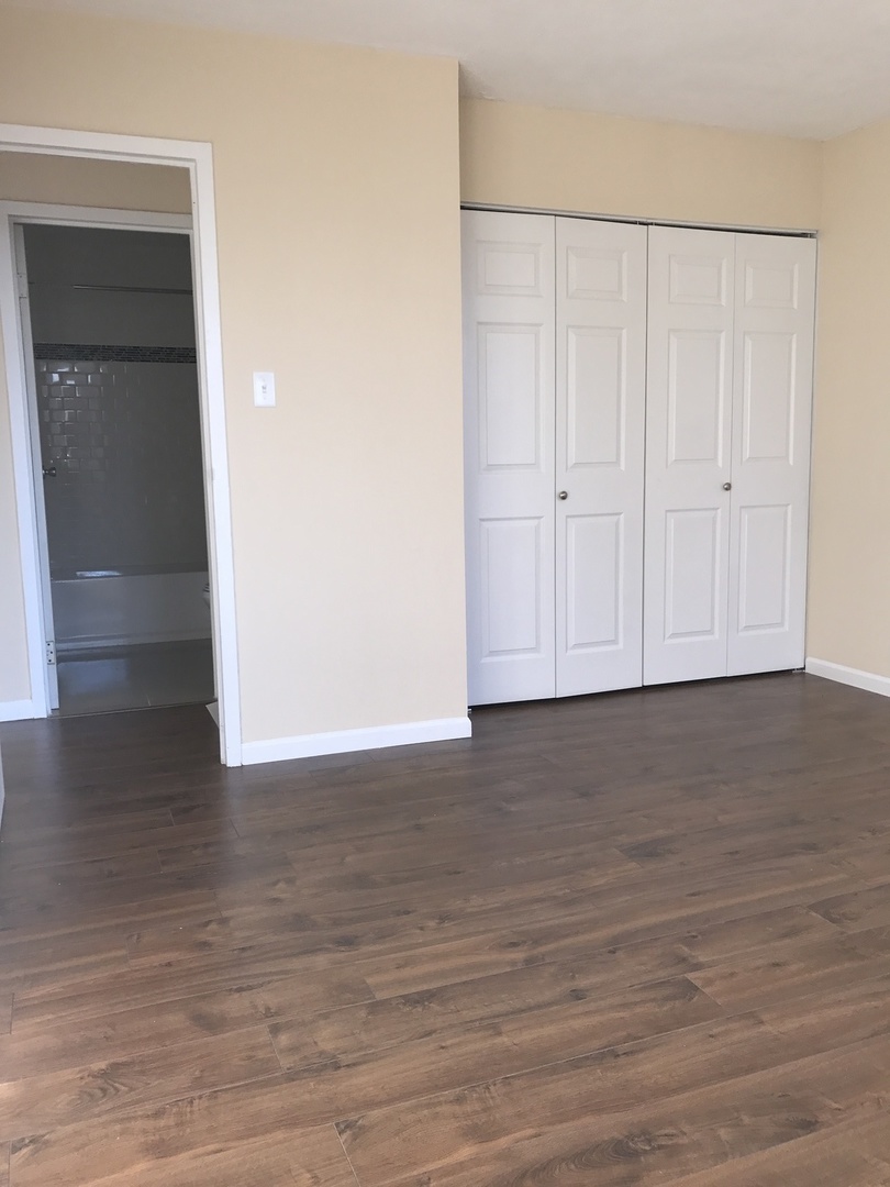10S472 Echo Lane, Unit 5 Willowbrook, IL 60527 - Photo 6 of 7 a view of an empty room with wooden floor