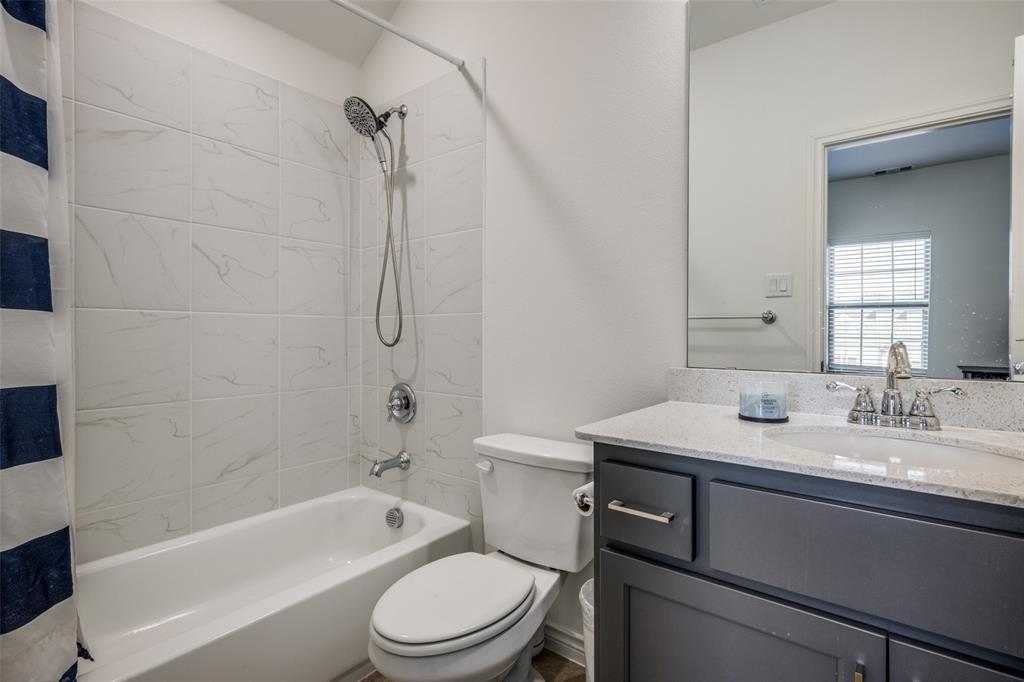 4804 Long Pond Trail Flower Mound, TX 76262 - Photo 19 of 22 a bathroom with a granite countertop sink toilet and shower