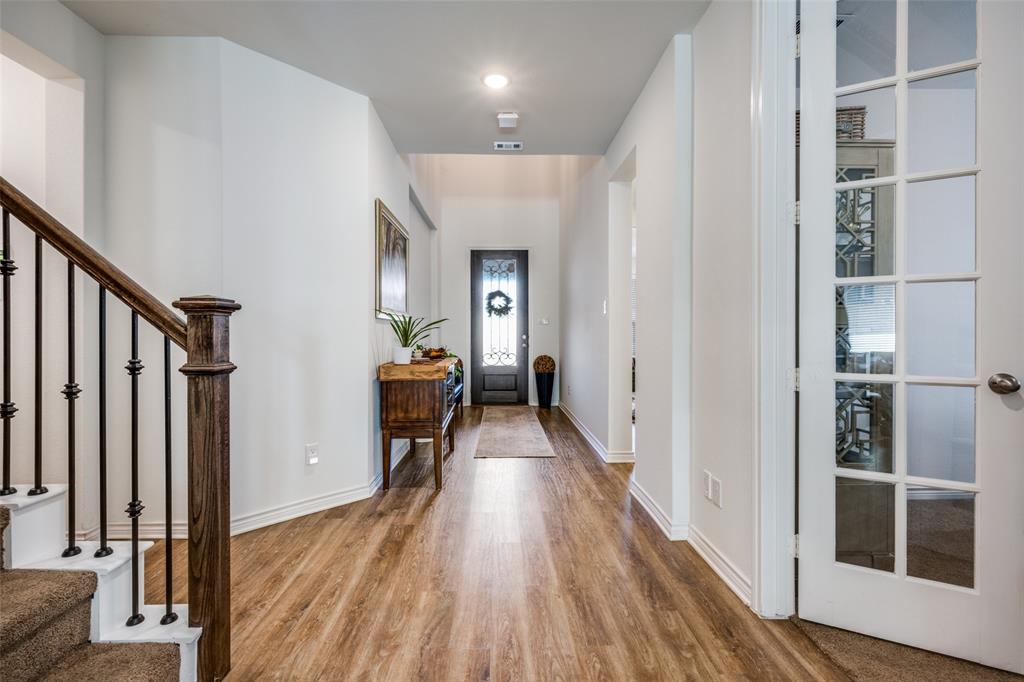 4804 Long Pond Trail Flower Mound, TX 76262 - Photo 3 of 22 a view of a hallway with wooden floor and staircase