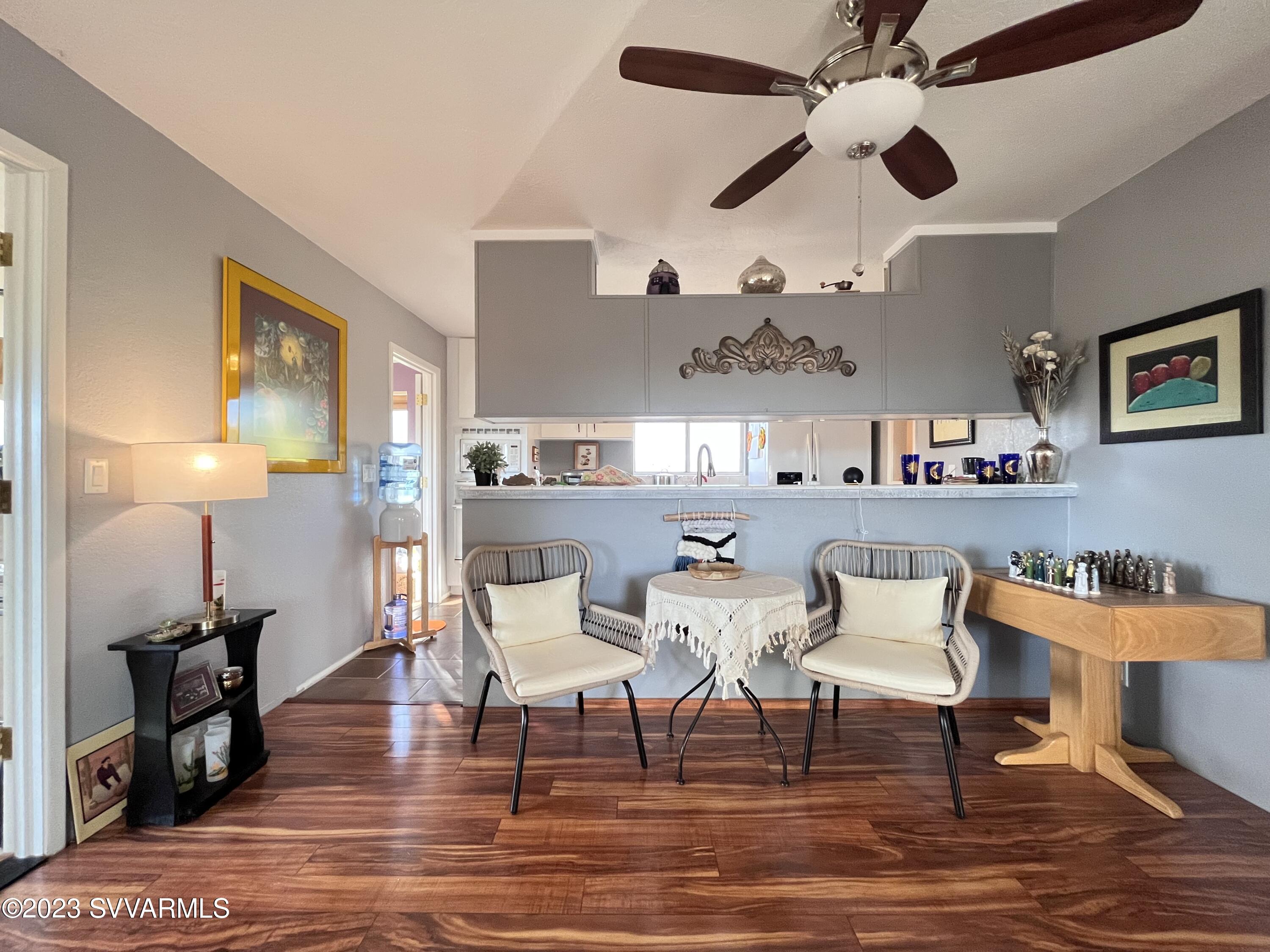 4605 Pima Way Rimrock, AZ 86335 - Photo 12 of 77 a dining room with stainless steel appliances kitchen island granite countertop a table chairs and a couch