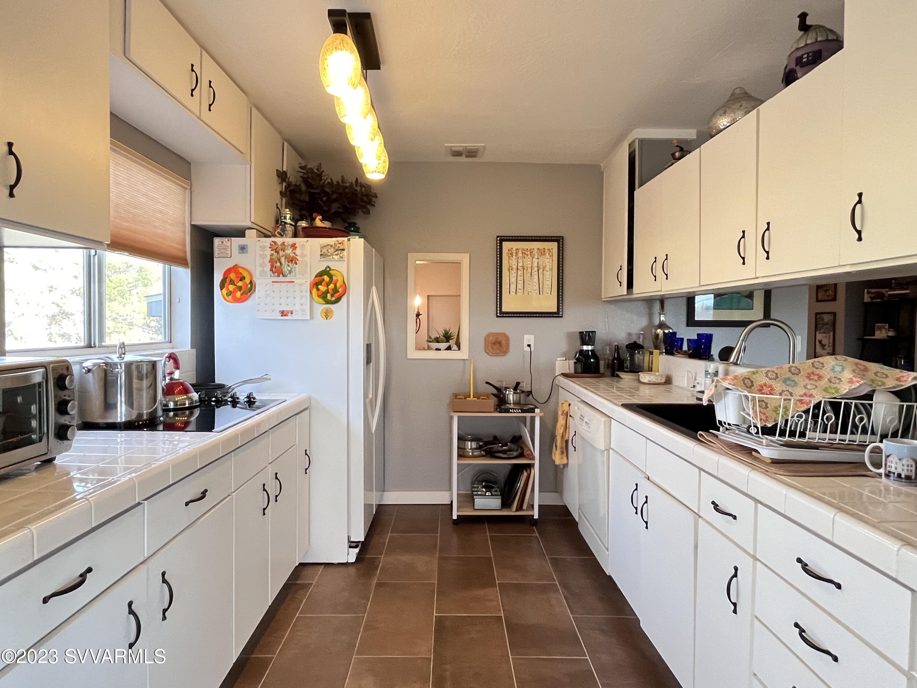 4605 Pima Way Rimrock, AZ 86335 - Photo 15 of 77 a kitchen with granite countertop a sink and cabinets