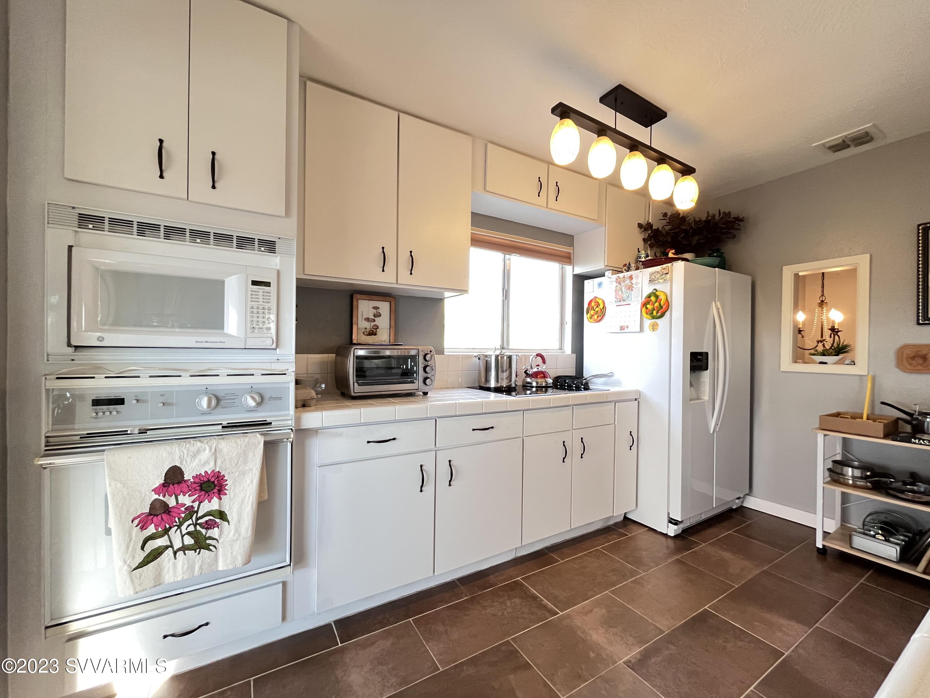 4605 Pima Way Rimrock, AZ 86335 - Photo 17 of 77 a kitchen with stainless steel appliances granite countertop a refrigerator sink and cabinets