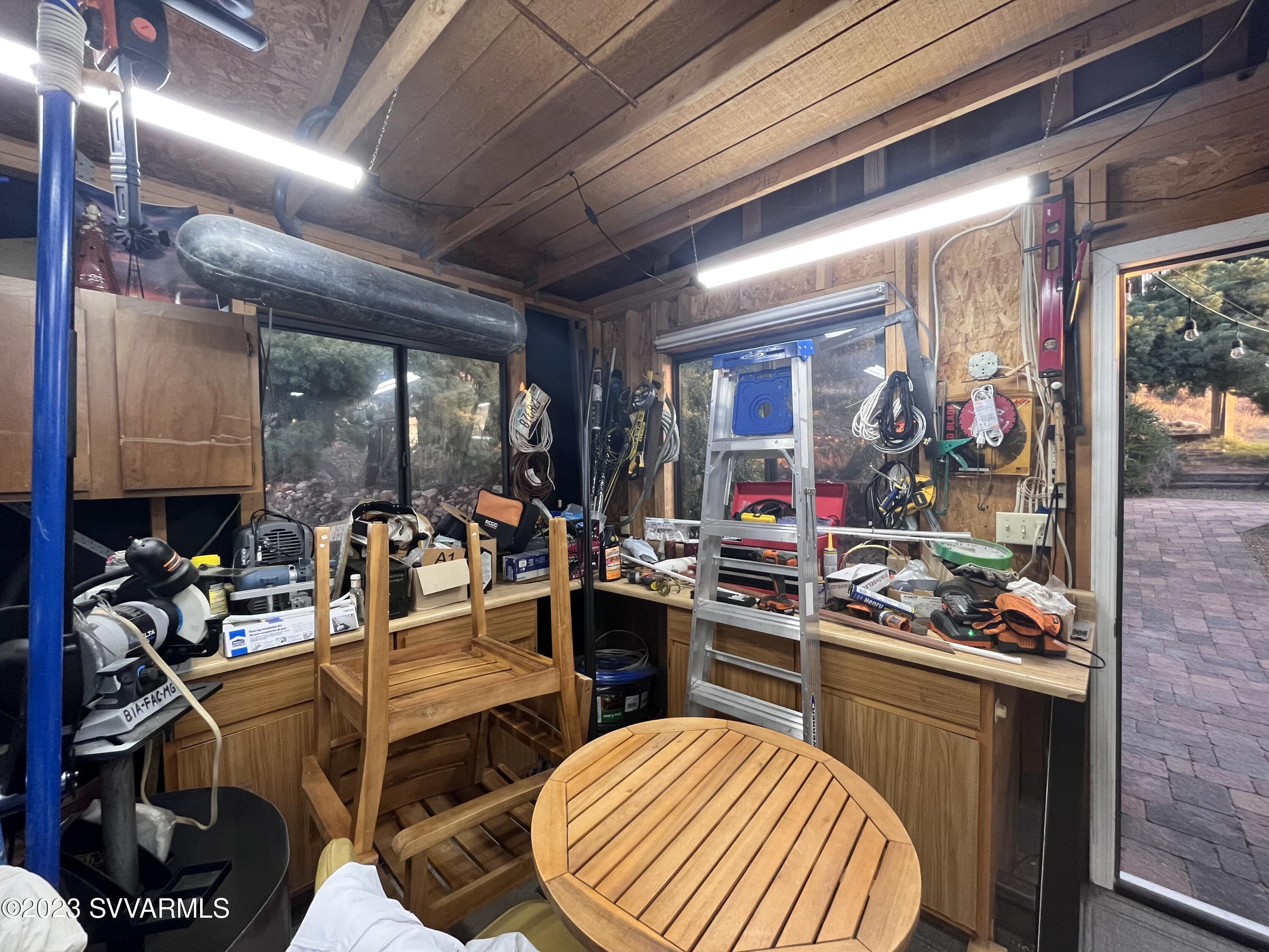 4605 Pima Way Rimrock, AZ 86335 - Photo 54 of 77 a room with lots of wooden furniture and a potted plant