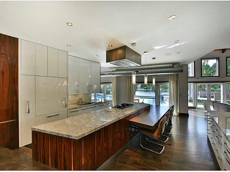 1 Seneca Road Sea Ranch Lakes, FL 33308 - Photo 15 of 35 a kitchen with stainless steel appliances granite countertop a stove and a refrigerator