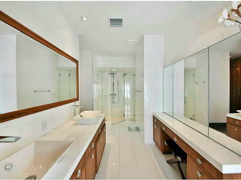 1 Seneca Road Sea Ranch Lakes, FL 33308 - Photo 21 of 35 a spacious bathroom with a double vanity sink a mirror and a shower
