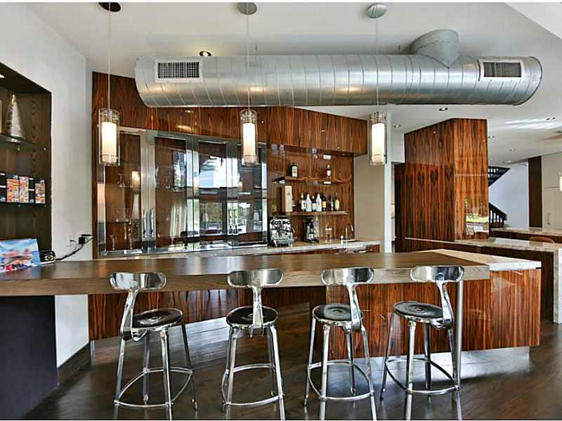 1 Seneca Road Sea Ranch Lakes, FL 33308 - Photo 6 of 35 a kitchen with a dining table chairs cabinets and wooden floor