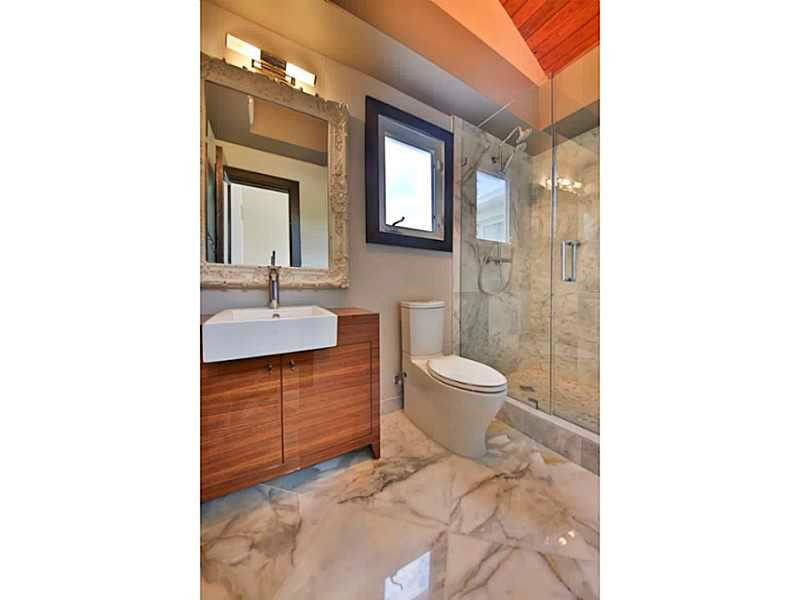 1 Seneca Road Sea Ranch Lakes, FL 33308 - Photo 8 of 35 a bathroom with a sink a toilet and shower