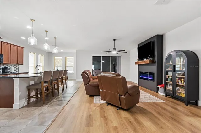 a kitchen with stainless steel appliances granite countertop a sink refrigerator and cabinets