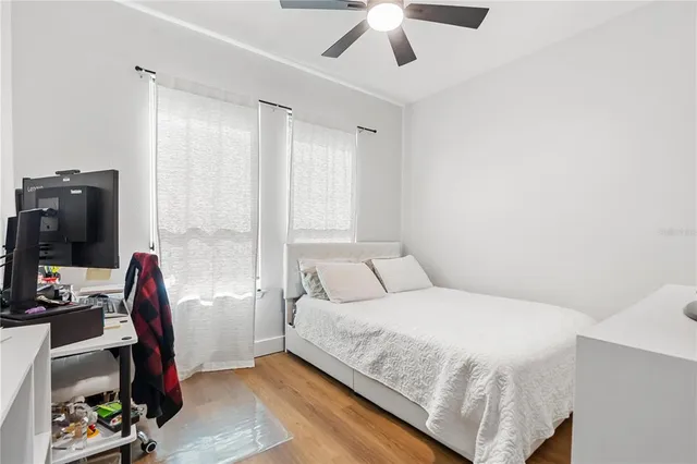 a room with pool table gym equipment and wooden floor