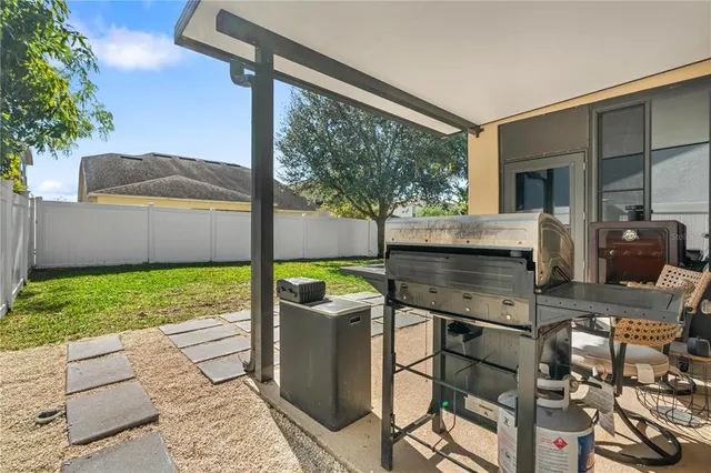 an aerial view of ocean and residential houses with outdoor space