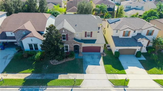 a large living room with stainless steel appliances kitchen island granite countertop furniture and a fireplace