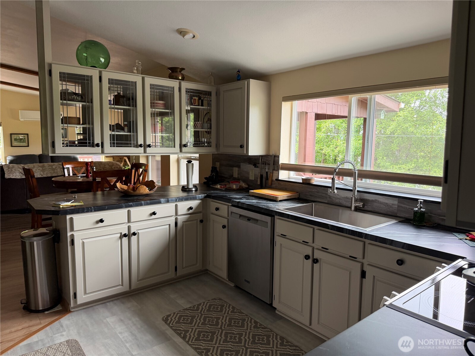 1171 Ray Hicks Street Raymond, WA 98577 - Photo 10 of 33 a kitchen with a sink and large windows