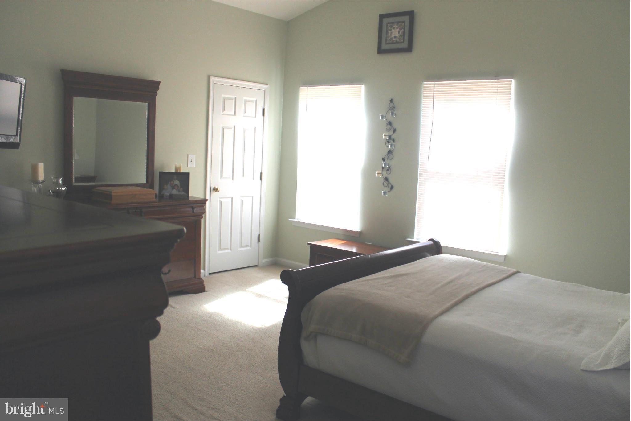 11544 Big Sandy Run Road Lusby, MD 20657 - Photo 9 of 12 a bedroom with a bed and a couch