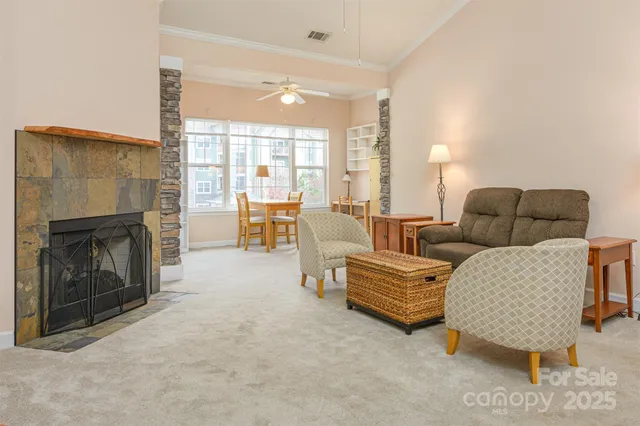 a living room with furniture and a fireplace