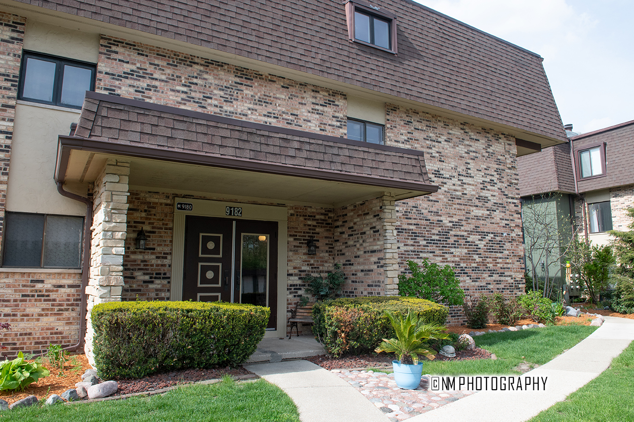 9182 S Road, Unit A Palos Hills, IL 60465 - Photo 1 of 16 a front view of a house with garden