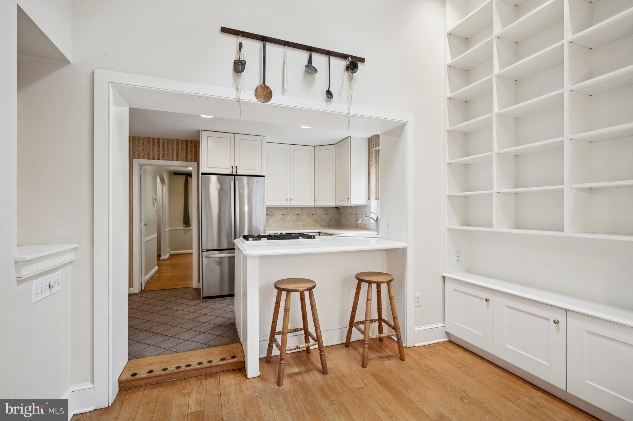 524 Lafayette Road Merion Station, PA 19066 - Photo 8 of 25 a kitchen with kitchen island a stove a refrigerator and wooden floor