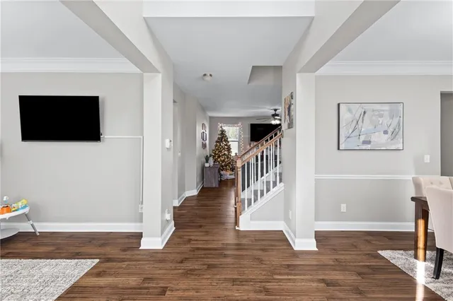 a view of a livingroom with wooden floor and a flat screen tv