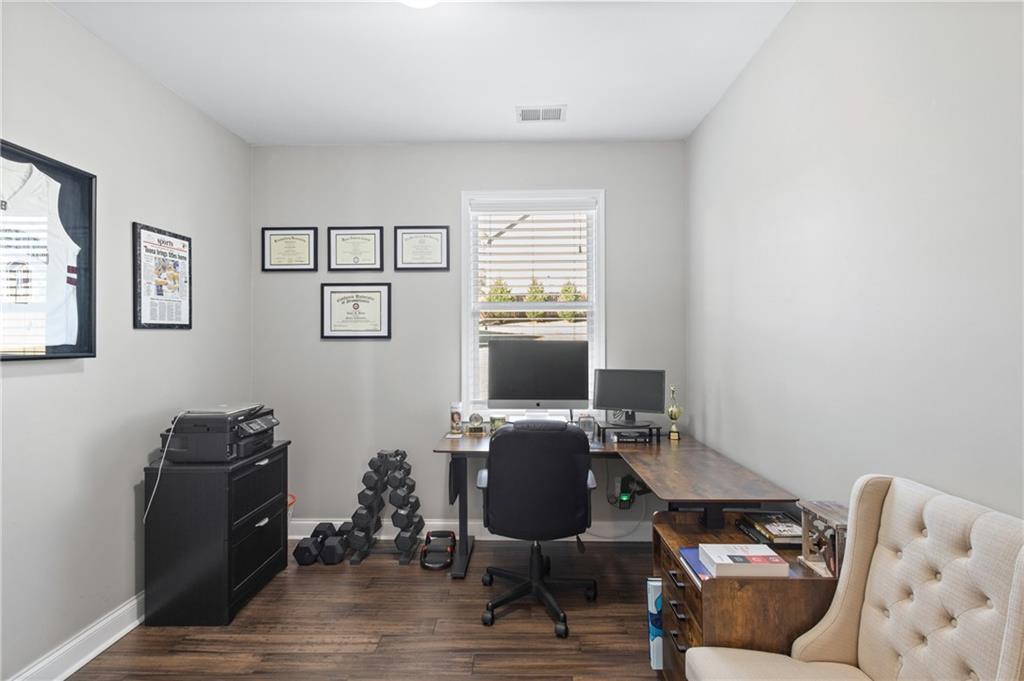 285 Paces Drive Lithia Springs, GA 30122 - Photo 21 of 45 a workspace with furniture and wooden floor