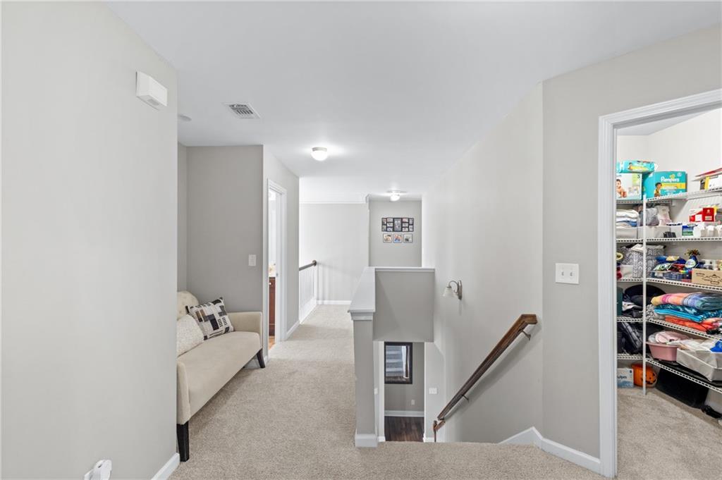 285 Paces Drive Lithia Springs, GA 30122 - Photo 22 of 45 a view of a hallway with workspace and a couch