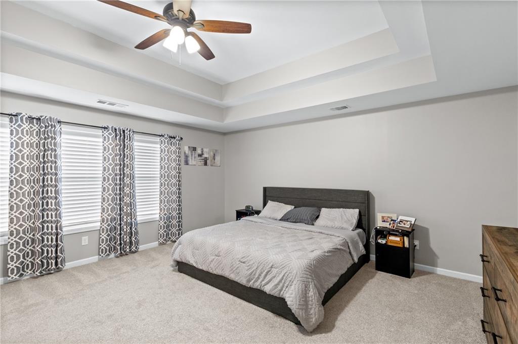 285 Paces Drive Lithia Springs, GA 30122 - Photo 24 of 45 a bedroom with a bed and a chandelier