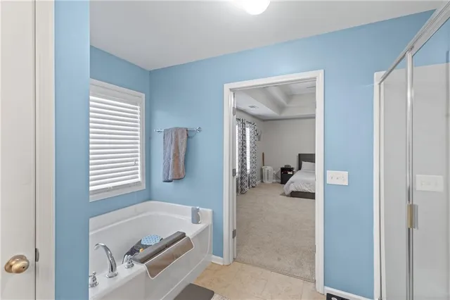a en suite bathroom with a tub and mirror