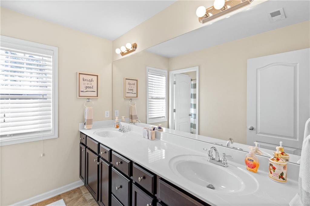 285 Paces Drive Lithia Springs, GA 30122 - Photo 31 of 45 a bathroom with a sink double vanity and a mirror