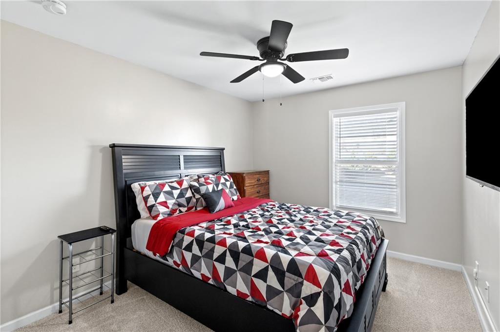 285 Paces Drive Lithia Springs, GA 30122 - Photo 32 of 45 a bedroom with a large bed and a tv