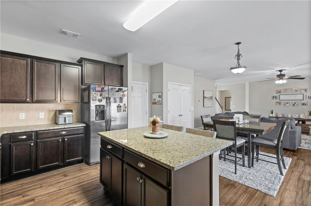 285 Paces Drive Lithia Springs, GA 30122 - Photo 10 of 45 a kitchen with granite countertop a sink cabinets and wooden floor