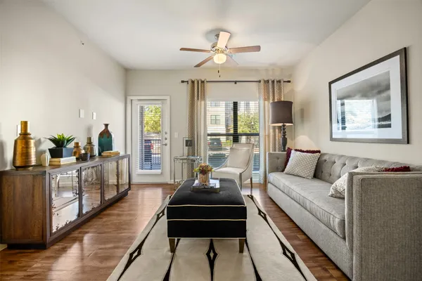 a living room with furniture and a chandelier
