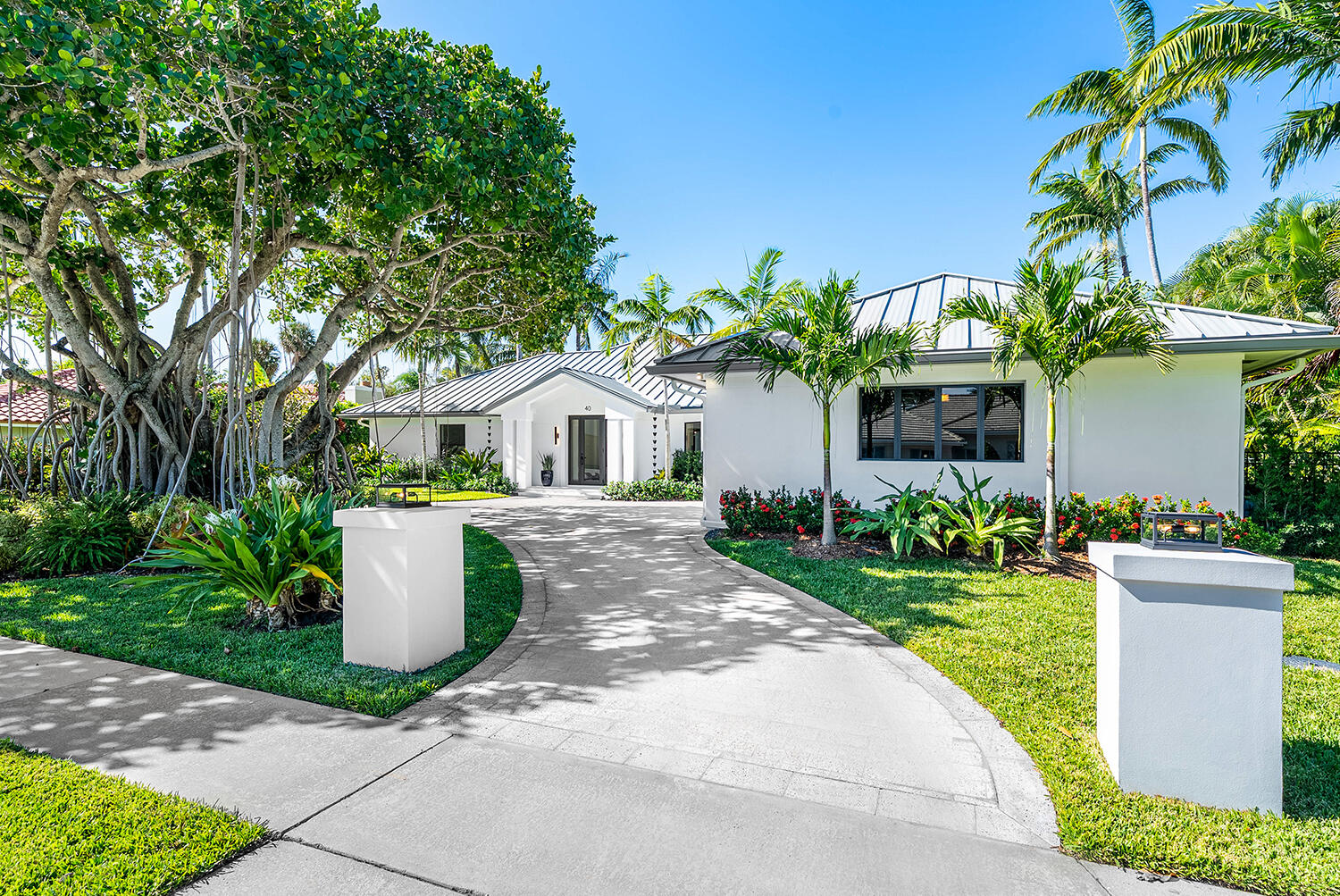 40 Spoonbill Road Manalapan, FL 33462 - Photo 11 of 67 a white house with trees in front of it