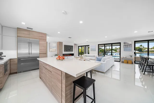 a kitchen with a sink a stove and chairs