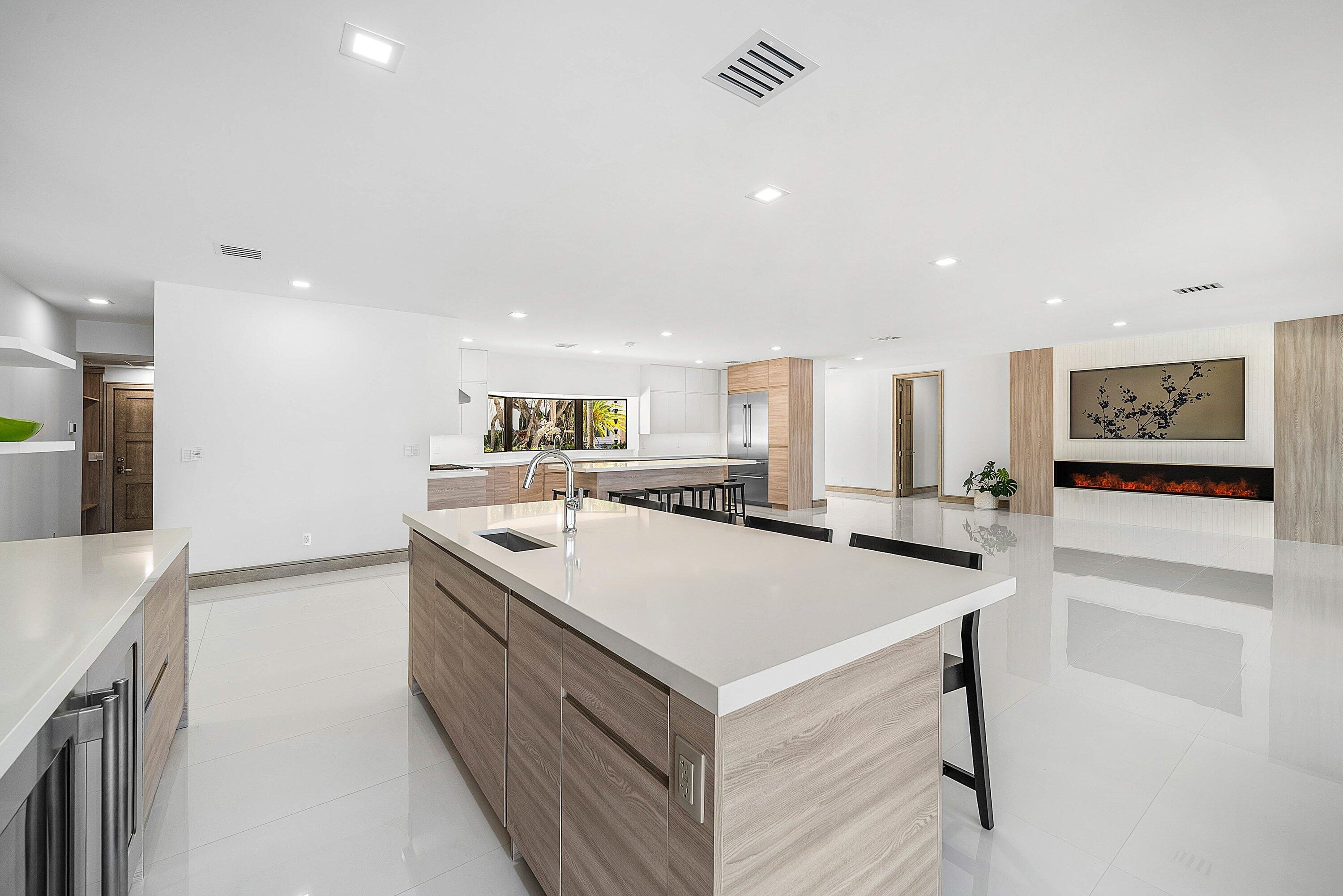 40 Spoonbill Road Manalapan, FL 33462 - Photo 31 of 67 a kitchen with a sink a stove and chairs