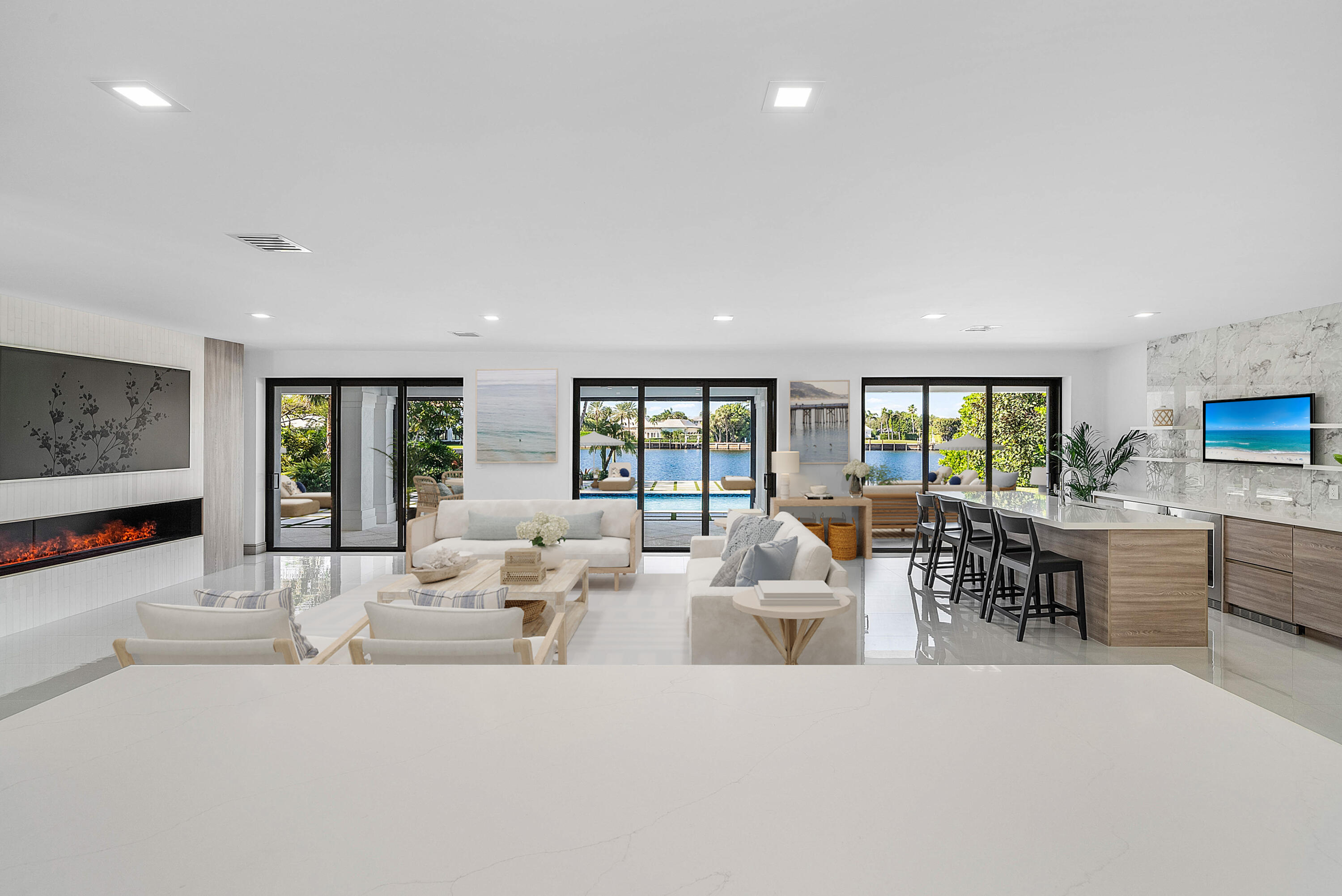 40 Spoonbill Road Manalapan, FL 33462 - Photo 32 of 67 a living room with furniture large window and flat screen tv