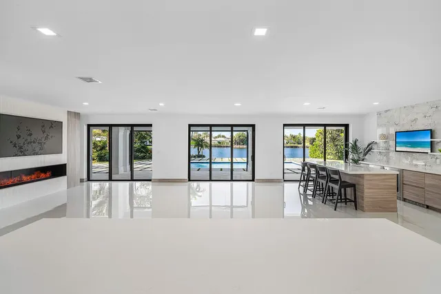 en empty room with windows and ceiling fan