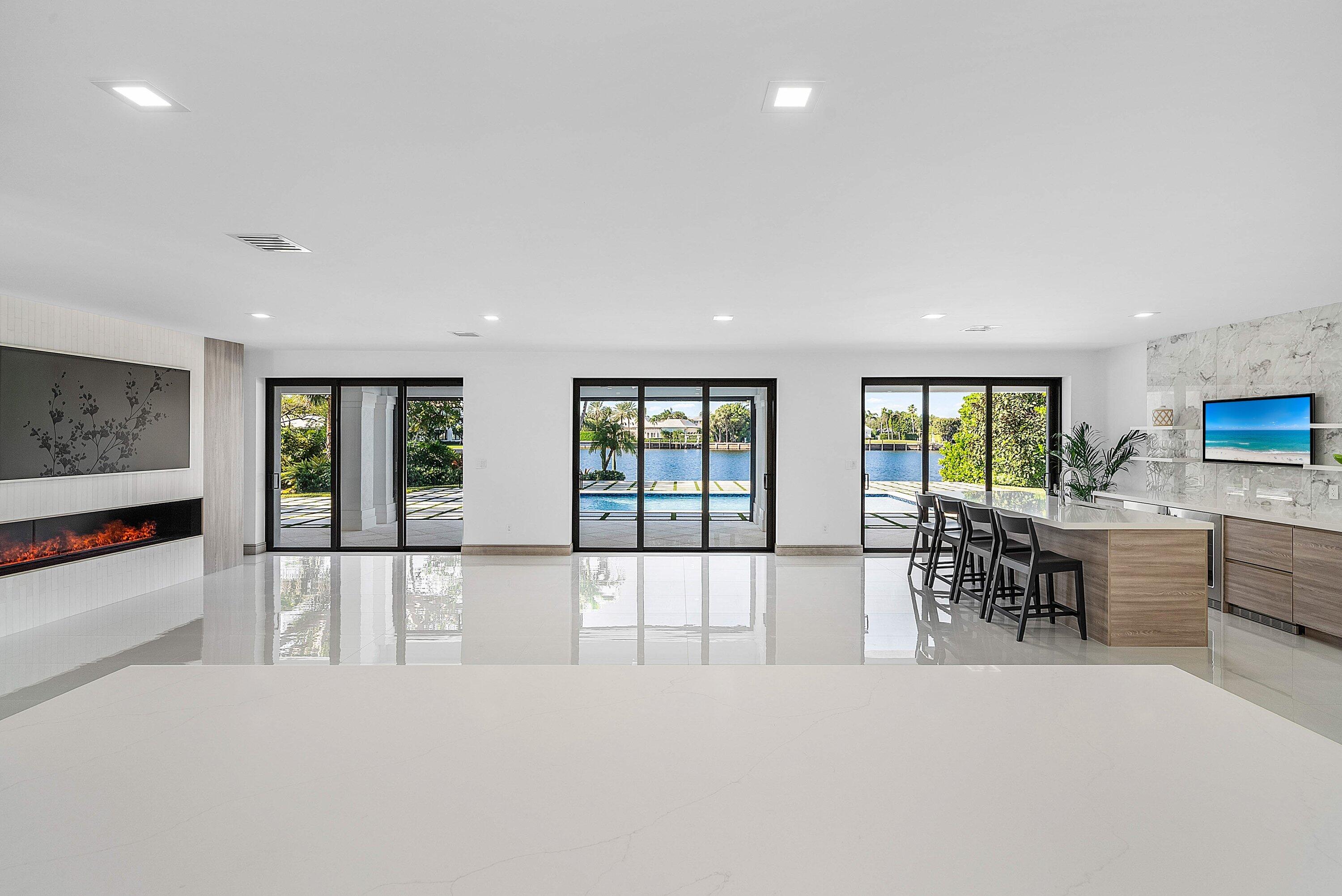 40 Spoonbill Road Manalapan, FL 33462 - Photo 33 of 67 a large white kitchen with large windows and table