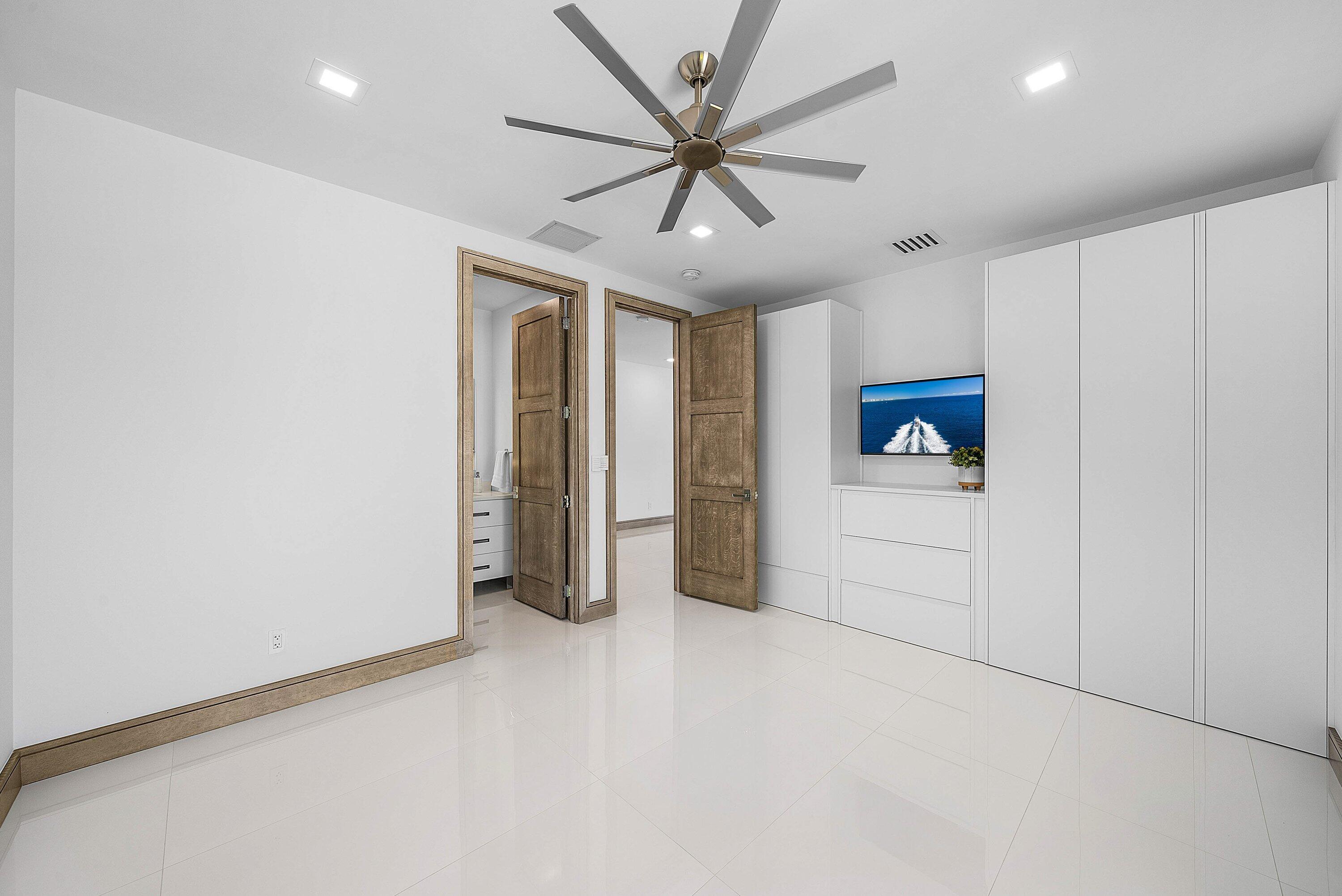 40 Spoonbill Road Manalapan, FL 33462 - Photo 34 of 67 an empty room with ceiling fan and windows