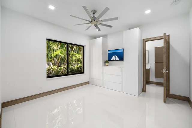 a bedroom with a large bed and a large window