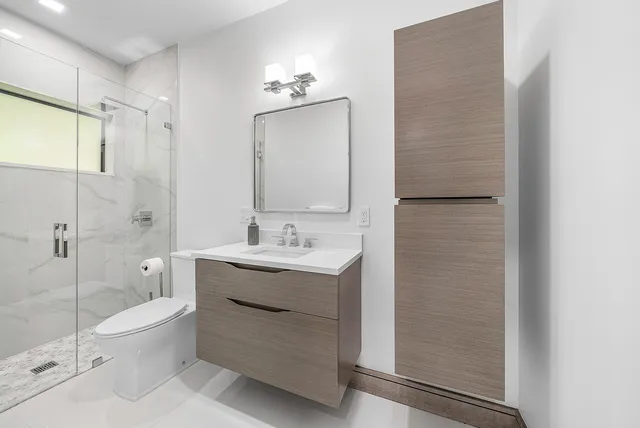 a bathroom with a sink vanity and a mirror