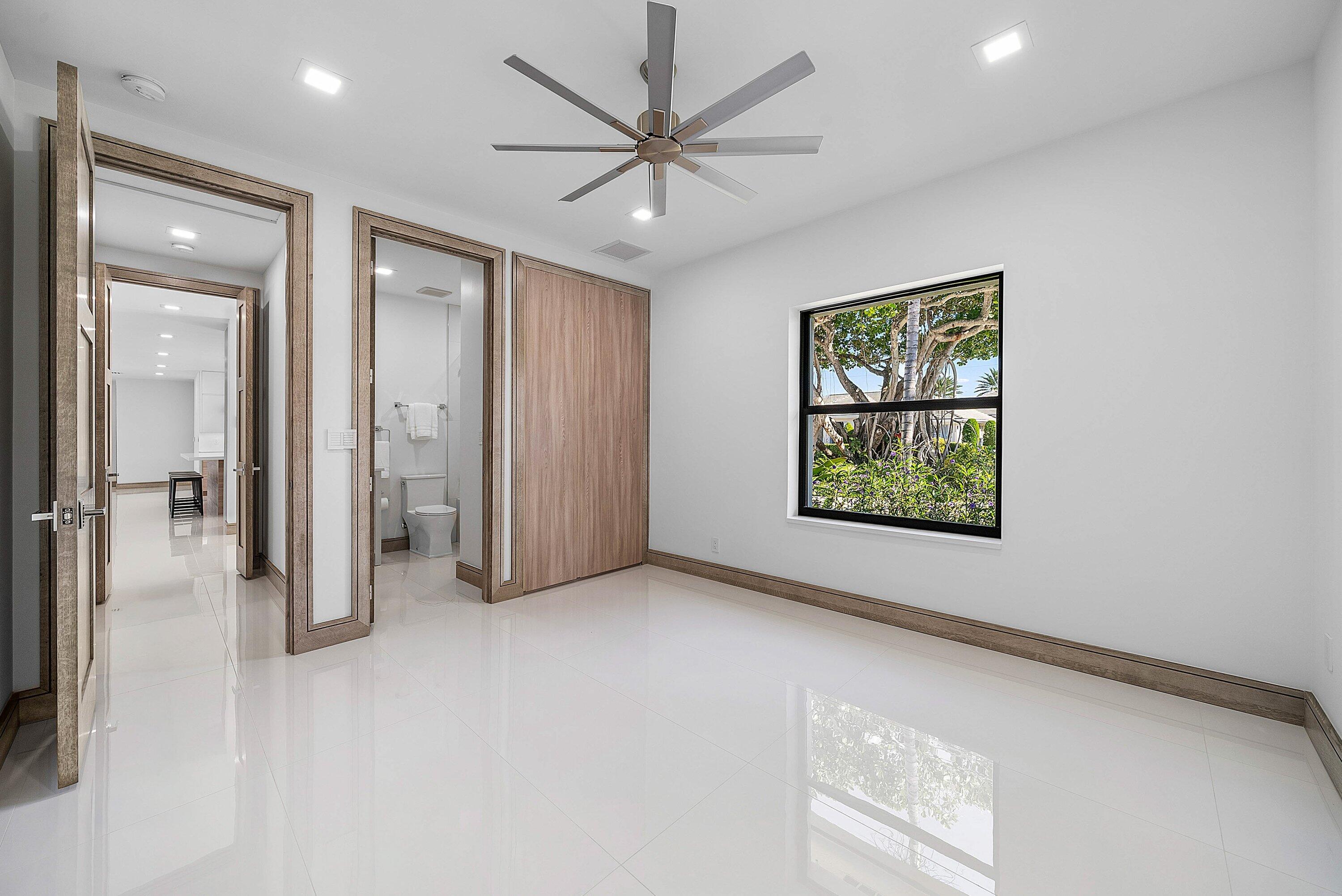 40 Spoonbill Road Manalapan, FL 33462 - Photo 43 of 67 en empty room with windows and ceiling fan