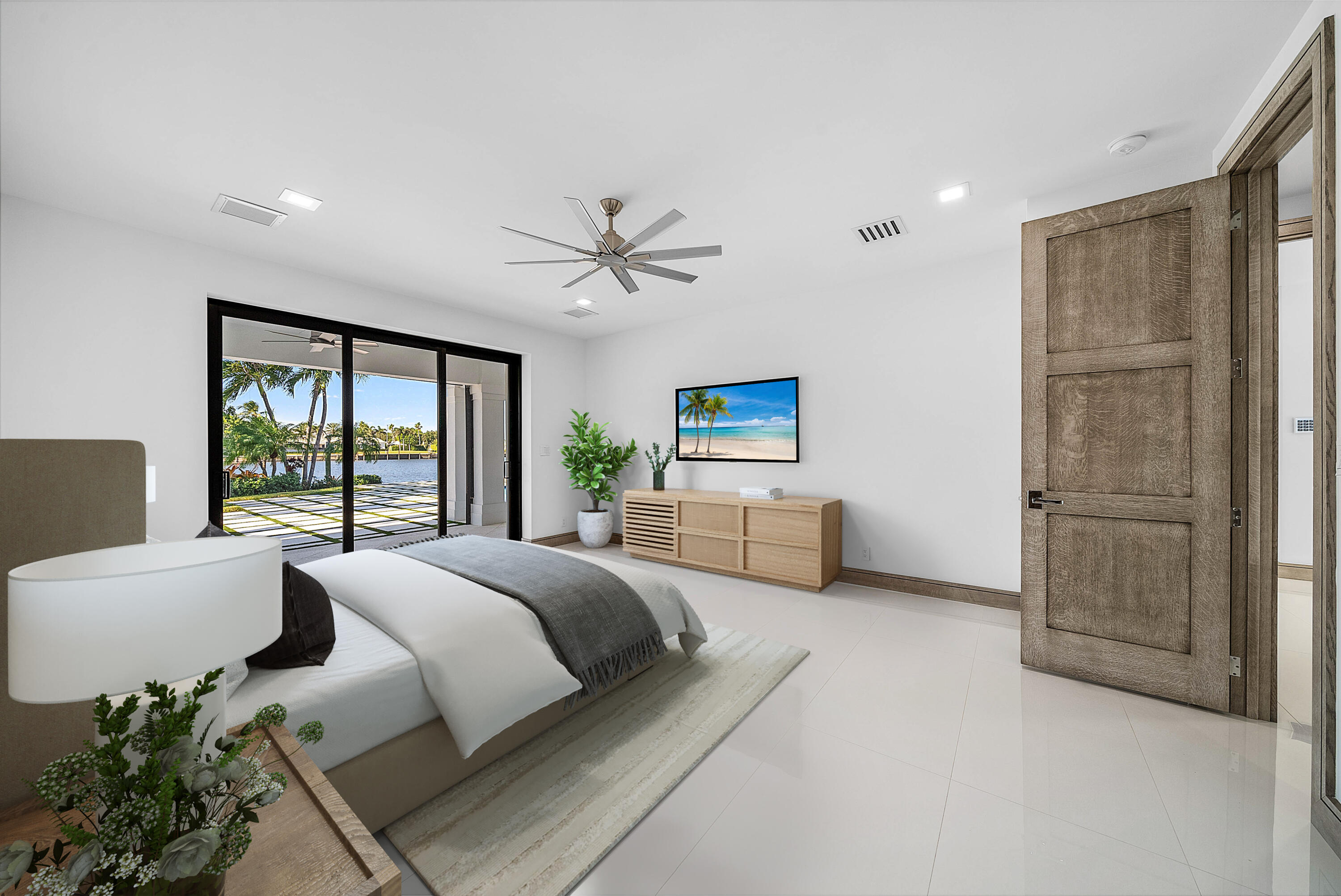 40 Spoonbill Road Manalapan, FL 33462 - Photo 45 of 67 a spacious bedroom with a large bed and a chandelier