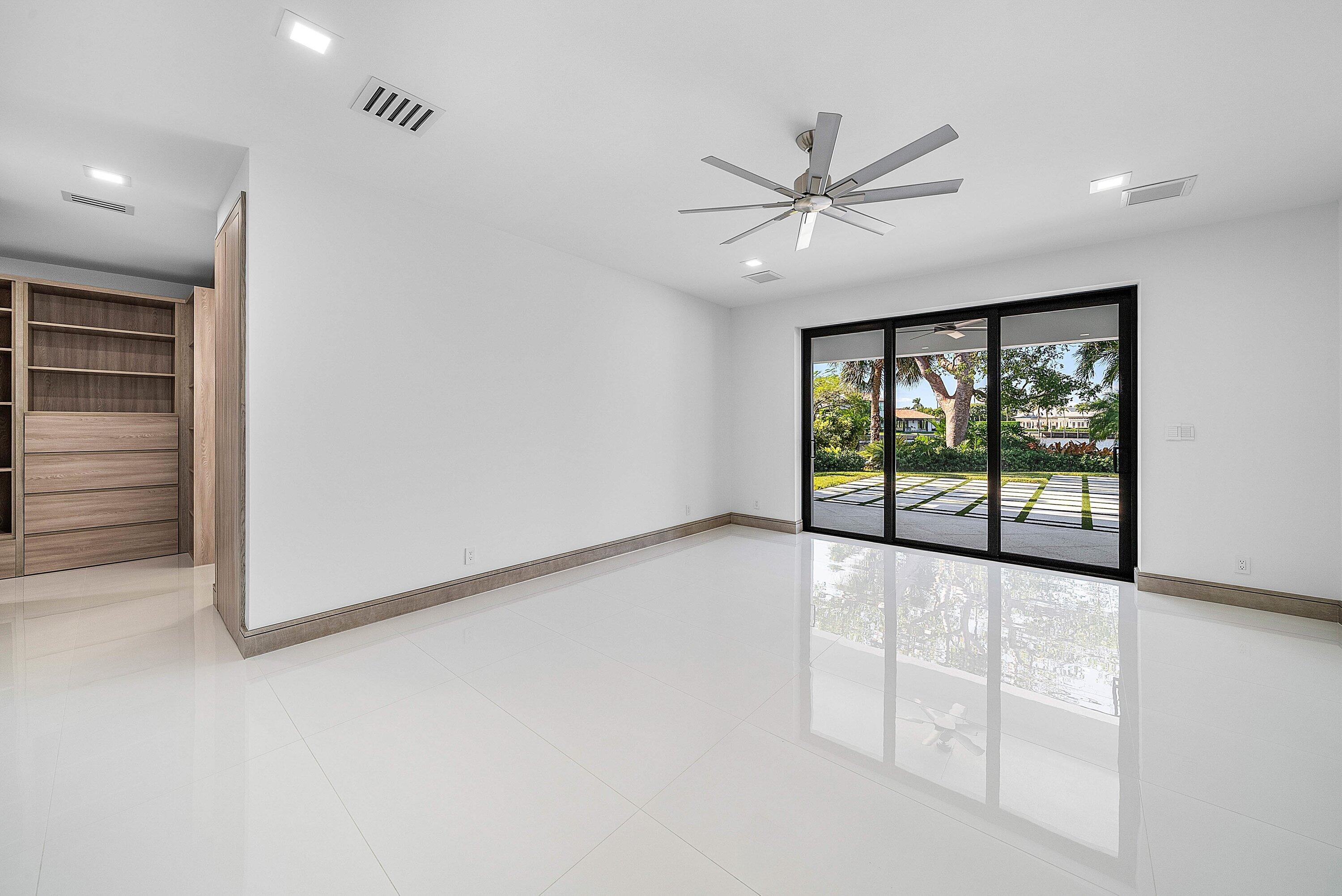 40 Spoonbill Road Manalapan, FL 33462 - Photo 48 of 67 an empty room with windows and chandelier fan